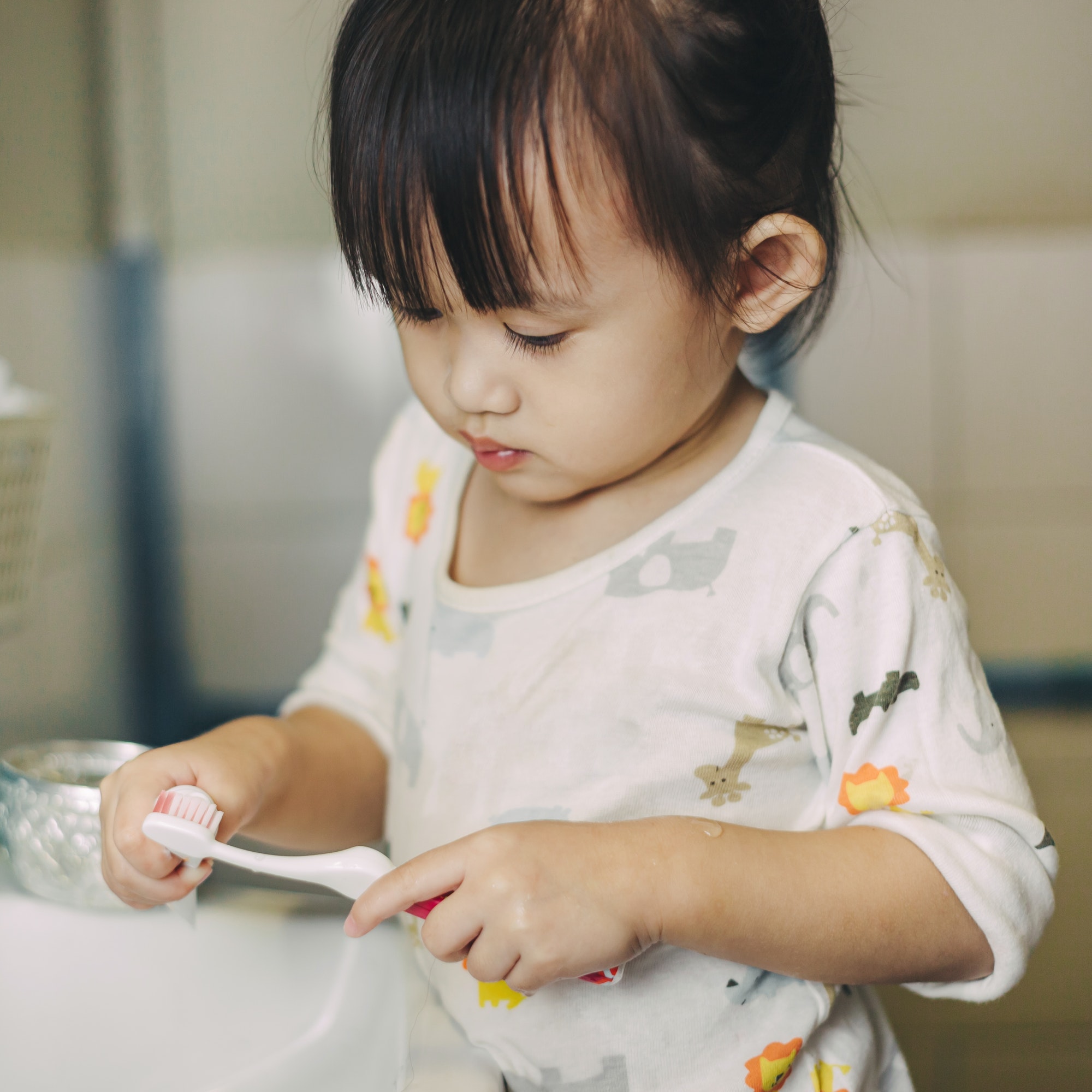 Little kids brushing teeth by herself as activity daily living